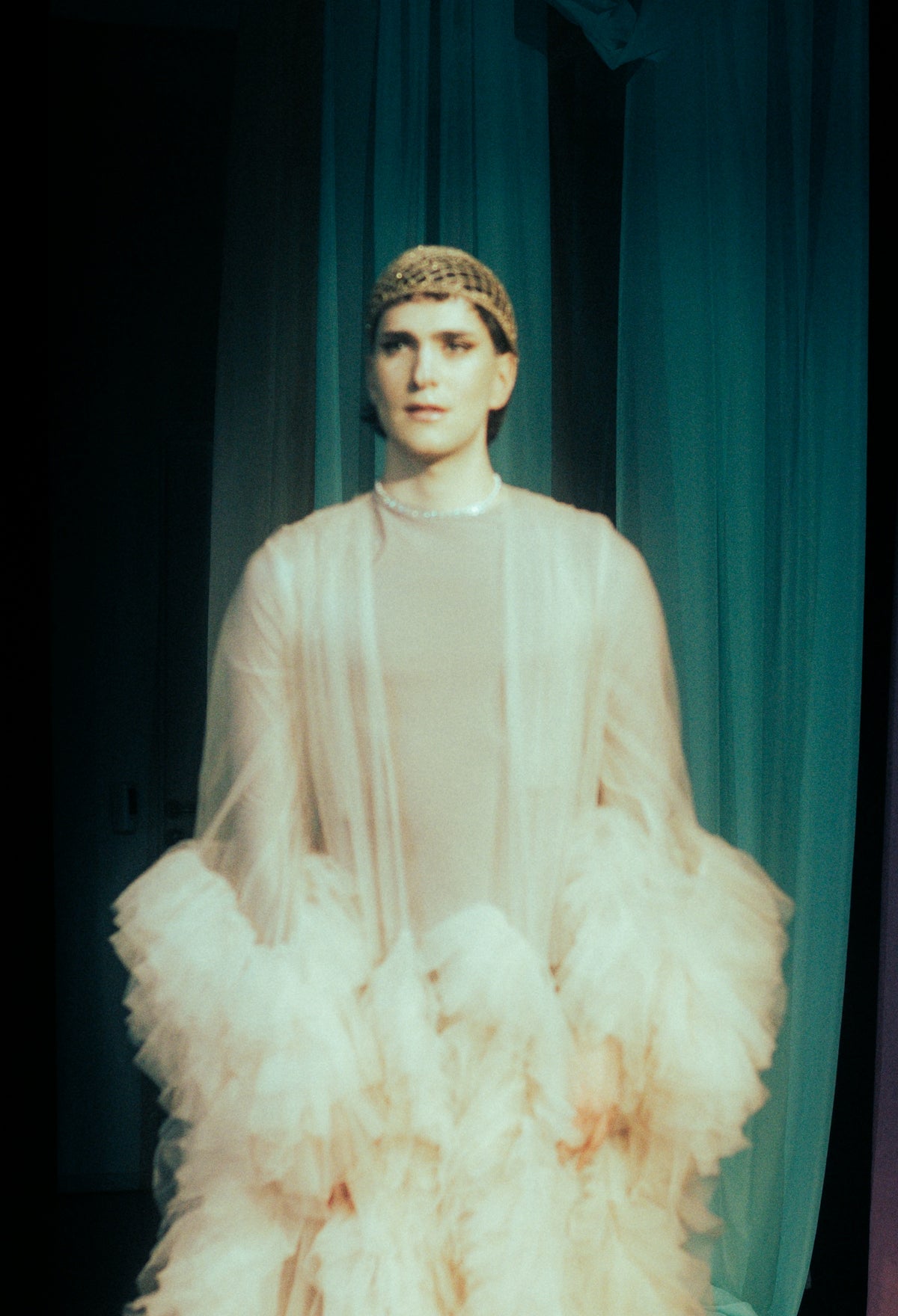 Person in ornate costume with ruffled skirt
