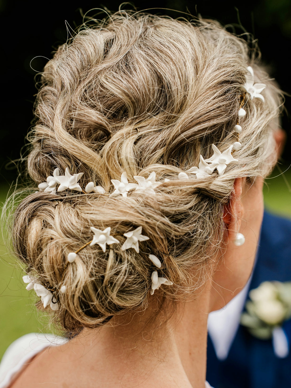 Elegant updo with star and pearl hair accessories